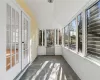 Unfurnished sunroom featuring lofted ceiling