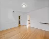 Spare room with light hardwood / wood-style floors and crown molding