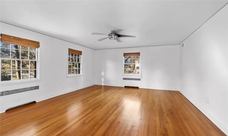 Spare room with ceiling fan and wood-type flooring