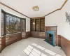 Carpeted living room featuring ornamental molding and wood walls