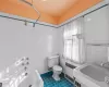 Bathroom featuring sink, tile patterned flooring, toilet, tile walls, and radiator heating unit