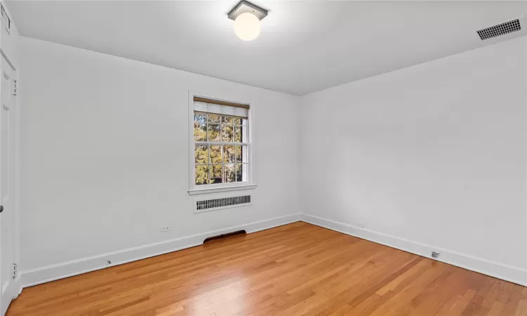 Unfurnished room with hardwood / wood-style floors