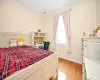 Bedroom with light hardwood / wood-style flooring