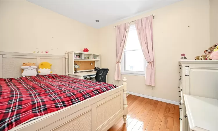 Bedroom with light hardwood / wood-style flooring