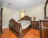 Bedroom with a closet and light hardwood / wood-style floors