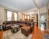 Living room with light hardwood / wood-style floors and an inviting chandelier