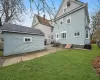 Back of house with a lawn and central AC