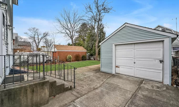 Garage featuring a lawn