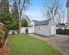 View of yard featuring a garage and an outbuilding