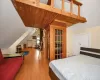 Bedroom featuring light hardwood / wood-style flooring, a closet, lofted ceiling, and wood ceiling