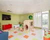 Workout area with light hardwood / wood-style flooring and a wall of windows