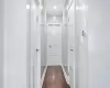 Hallway featuring dark hardwood / wood-style floors and crown molding