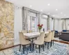 Dining area with a wall unit AC, ornamental molding, and hardwood / wood-style flooring