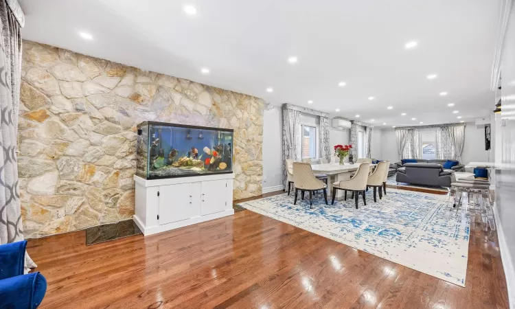 Dining room featuring hardwood / wood-style floors and a wall mounted air conditioner