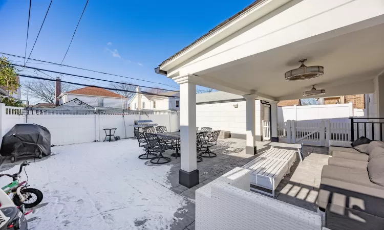 View of patio featuring area for grilling and ceiling fan