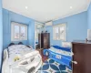 Bedroom featuring a wall mounted AC, crown molding, a closet, and wood-type flooring