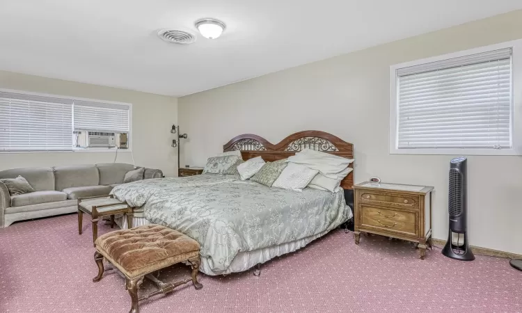 Carpeted bedroom with cooling unit