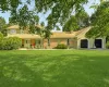 View of front facade featuring a garage and a front lawn