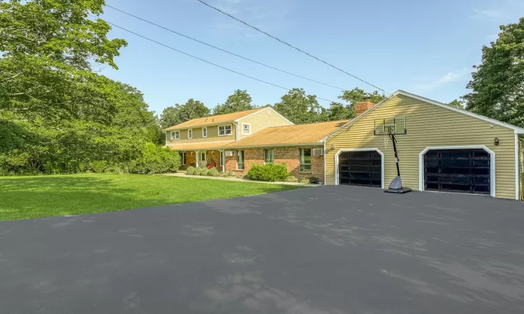 View of front of house featuring a garage and a front lawn