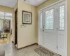 Foyer entrance featuring plenty of natural light, light hardwood / wood-style floors, and an inviting chandelier