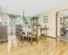 Dining space with light hardwood / wood-style floors, baseboard heating, and a chandelier