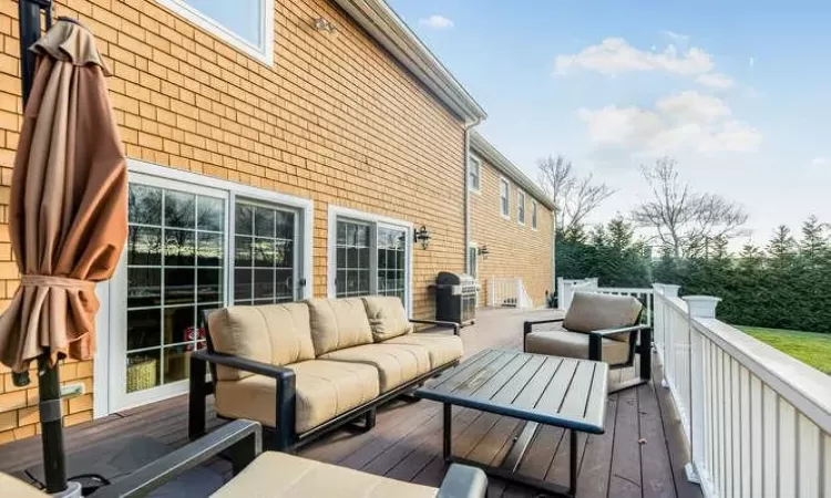 Deck featuring outdoor lounge area and area for grilling