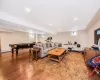 Game room with hardwood / wood-style floors and billiards