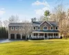 View of front facade with a porch, a garage, and a front lawn