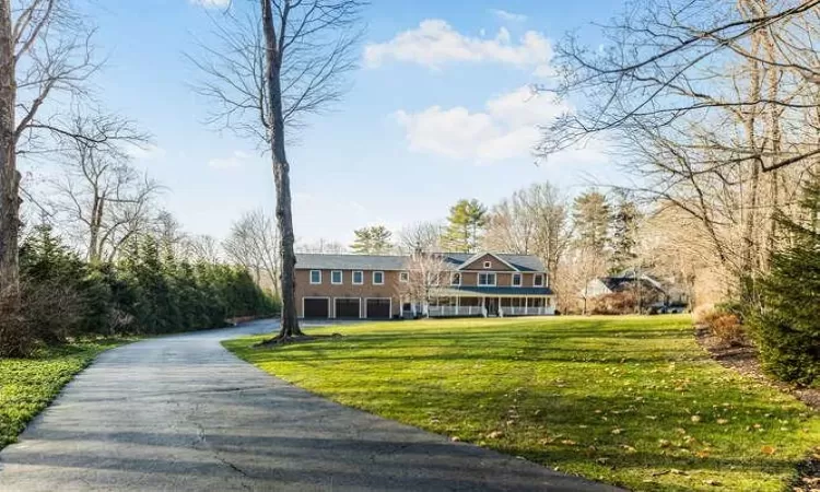 View of front of home featuring a front yard and a garage