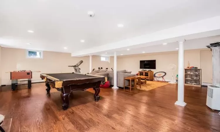 Game room with wood-type flooring and billiards