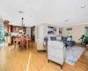 Living room with crown molding and light hardwood / wood-style flooring