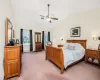 Bedroom featuring carpet, vaulted ceiling, and ceiling fan