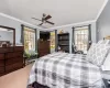 Bedroom featuring multiple windows, ceiling fan, and ornamental molding