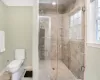 Bathroom with tile patterned floors, toilet, and a shower with door