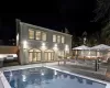 Back house at twilight with a patio area