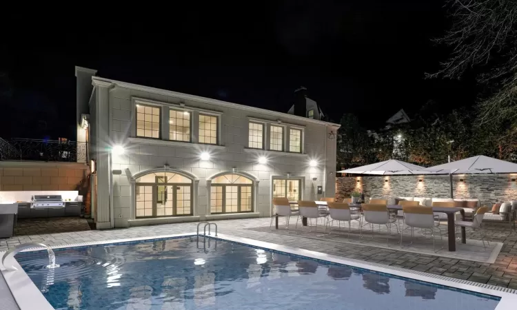 Back house at twilight with a patio area