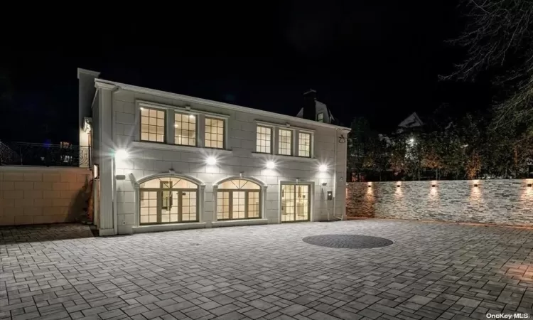 Back house at twilight with french doors