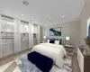 Bedroom featuring light wood-type flooring and crown molding (STAGED)