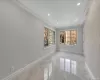 Empty room featuring a textured ceiling and crown molding