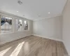 Unfurnished room with light hardwood / wood-style floors, a baseboard radiator, and ornamental molding