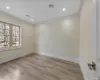 Empty room featuring crown molding, light hardwood / wood-style flooring, and a baseboard radiator