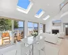 Dining space featuring plenty of natural light, high vaulted ceiling, wood ceiling, and light wood-type flooring