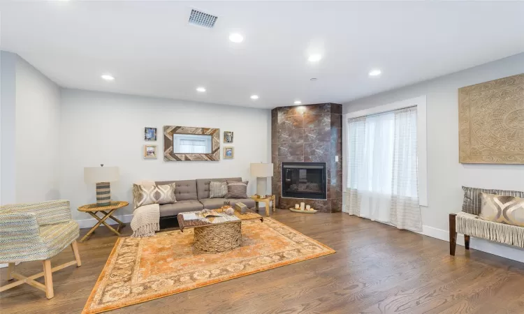 Living room featuring dark hardwood / wood-style flooring and a fireplace