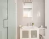 Bathroom featuring vanity, toilet, and a shower with shower door