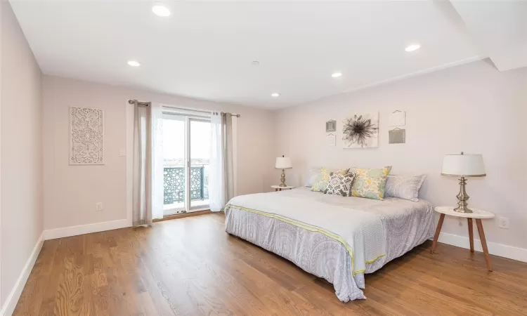 Bedroom with access to exterior and wood-type flooring