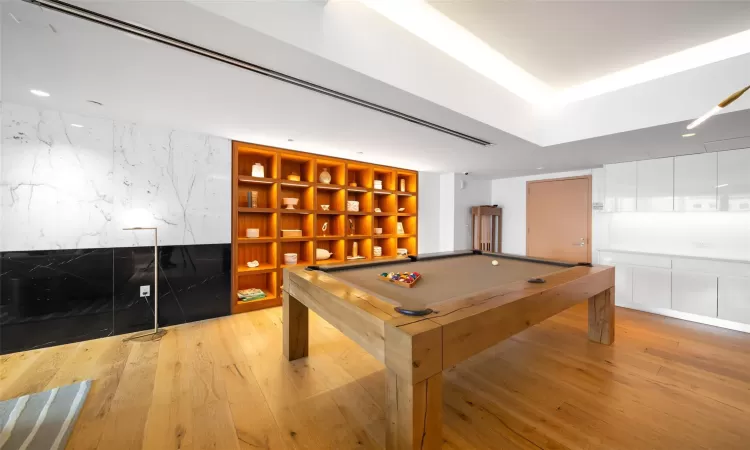 Game room featuring billiards, light wood-type flooring, and built in features