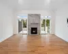 Unfurnished living room with light hardwood / wood-style flooring and a high end fireplace