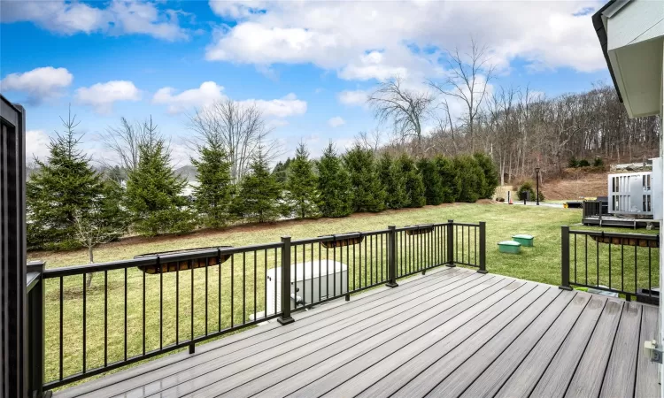 Wooden deck featuring a lawn