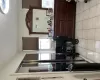 Kitchen featuring stainless steel appliances, a breakfast bar, light tile patterned flooring, and backsplash