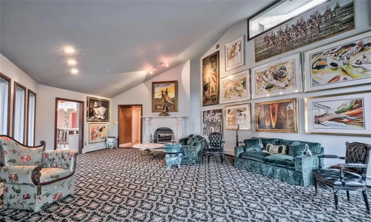 Living room featuring carpet floors, vaulted ceiling